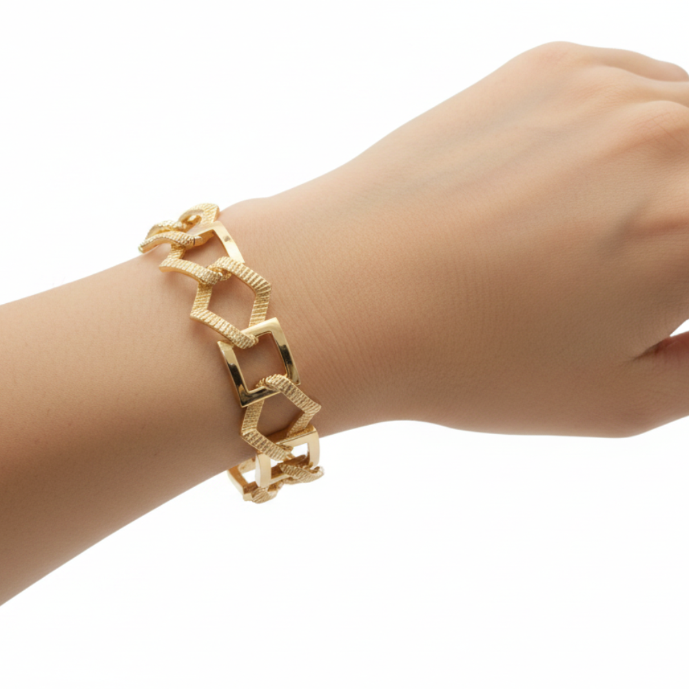 Gold geometric chain cuff bracelet on white background