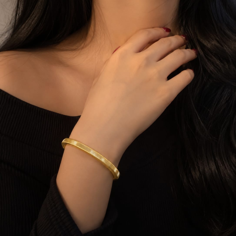 Gold bangle on wrist