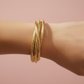 Gold plated snake chain bracelet set worn on wrist