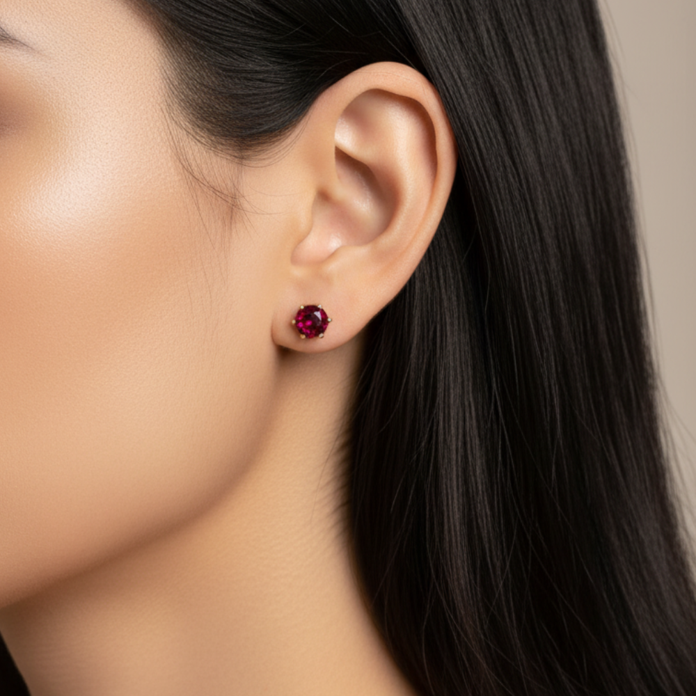 Ruby crystal stud earrings 6mm worn on ear with black hair