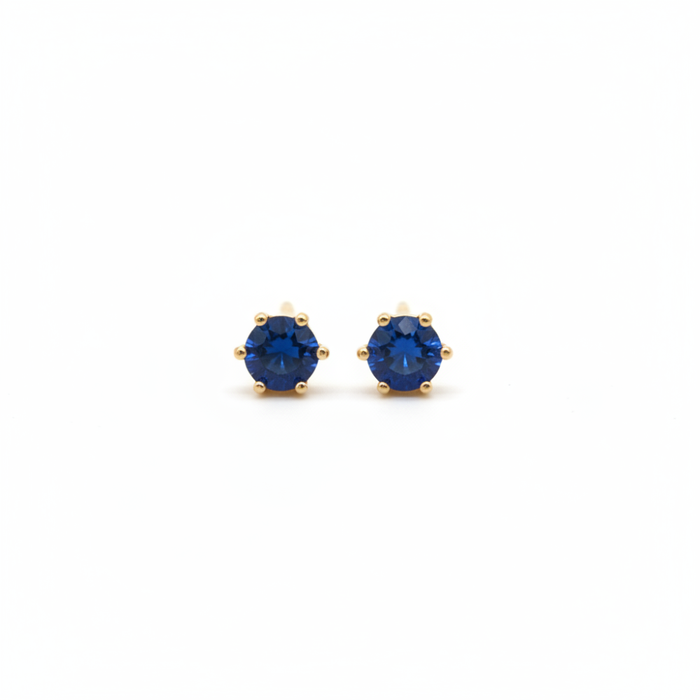 Navy blue crystal stud earrings 5mm gold prong setting on white background