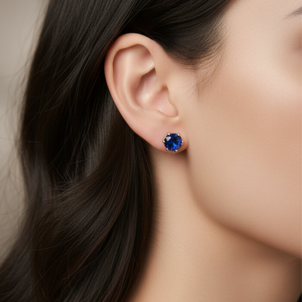 Navy blue crystal stud earrings 5mm worn on ear with black hair