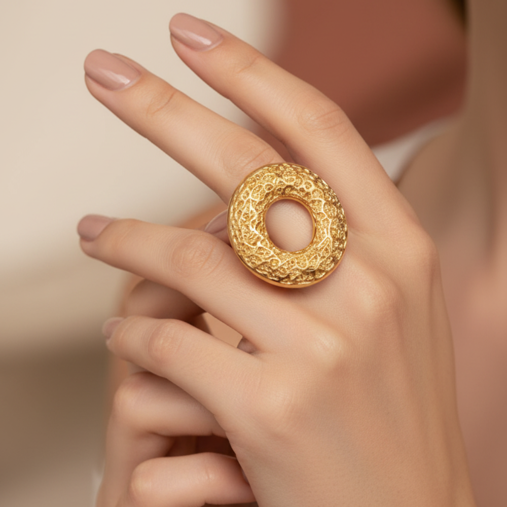 Gold open circle adjustable ring worn on woman's hand