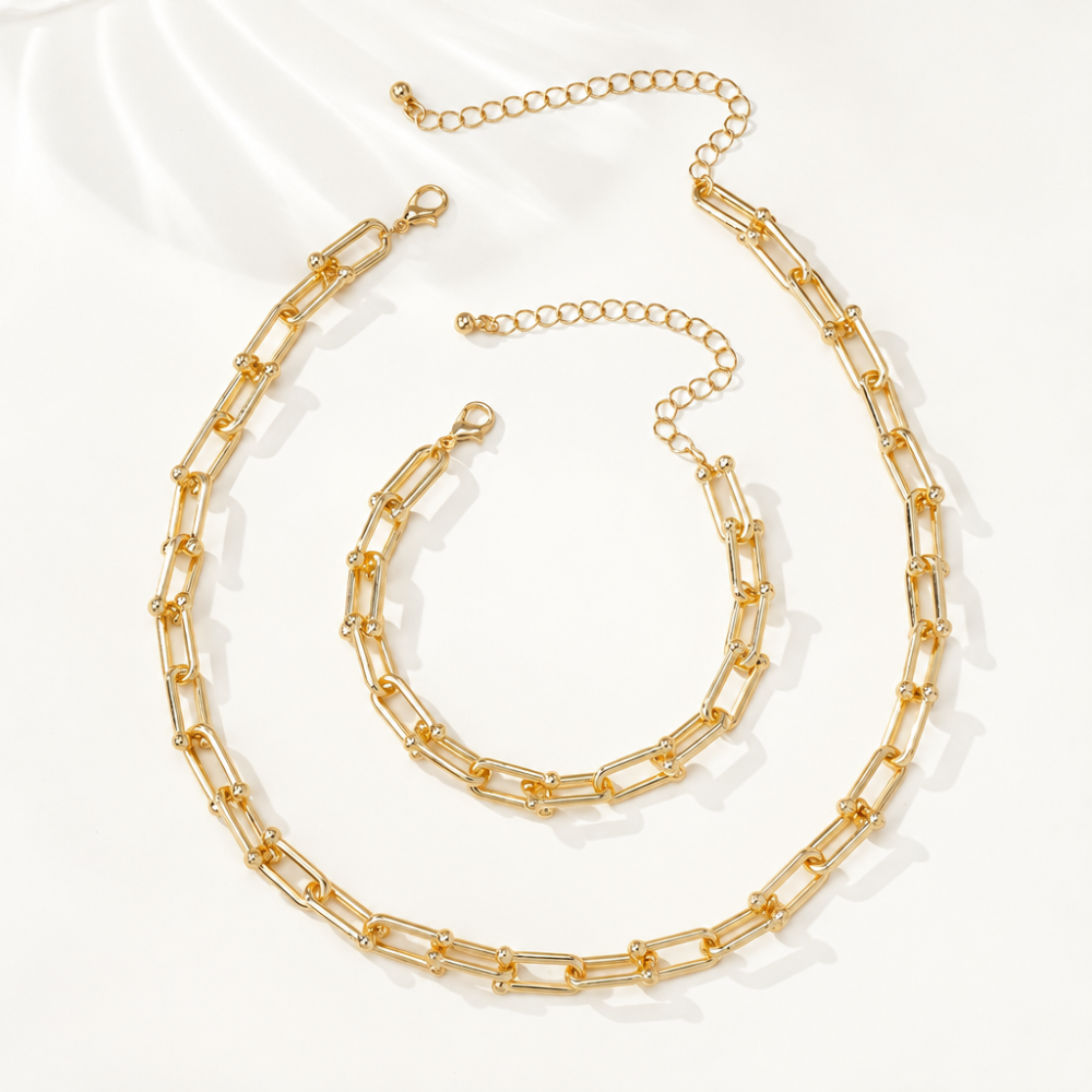 Model wearing a gold-plated necklace and matching bracelet set