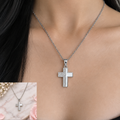 Silver-tone stainless steel Latin cross necklace worn on a model