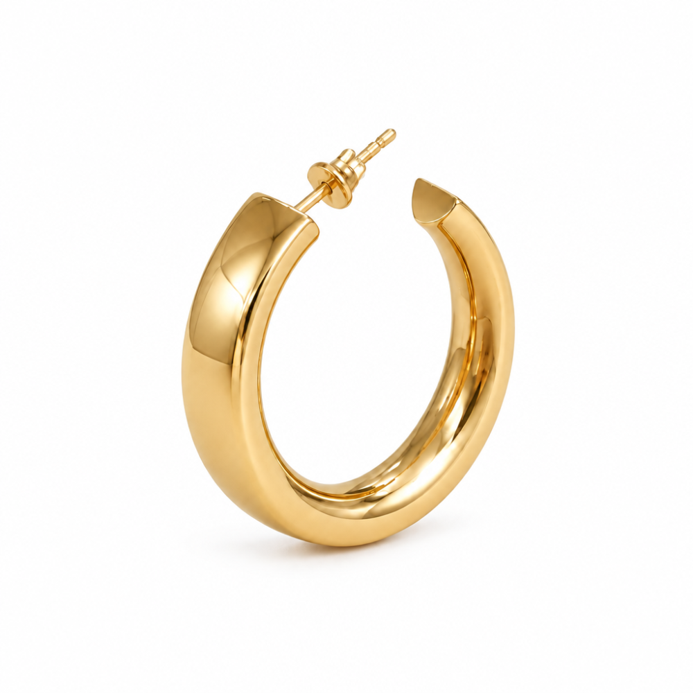Single wide flat gold hoop earring with stud fastening on a white background