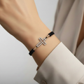 Silver cross bracelet on wrist – side view