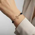 Gold plated cross bracelet on wrist – front view