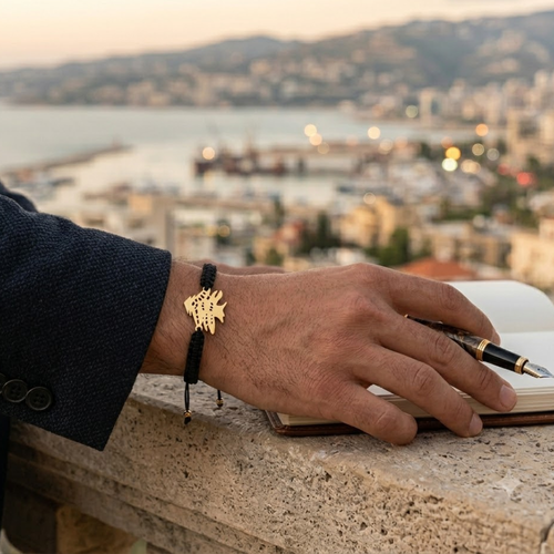 Men's Cedar Tree bracelet worn on wrist with Beirut cityscape in background