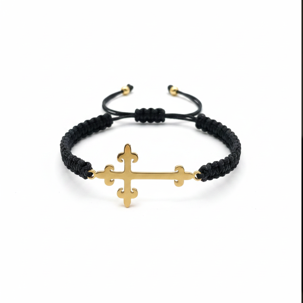 Gold cross bracelet on white background