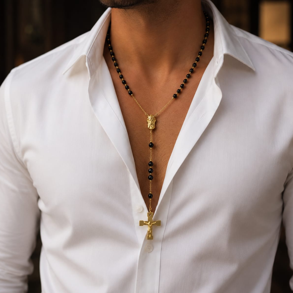 Gold stainless steel rosary necklace with black beads and cross pendant worn by man