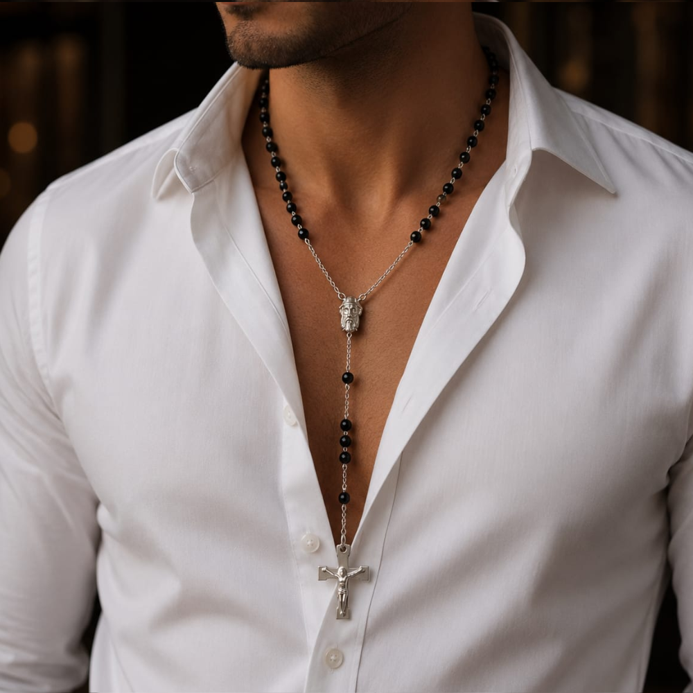 Silver stainless steel rosary necklace with black beads and cross pendant worn by man