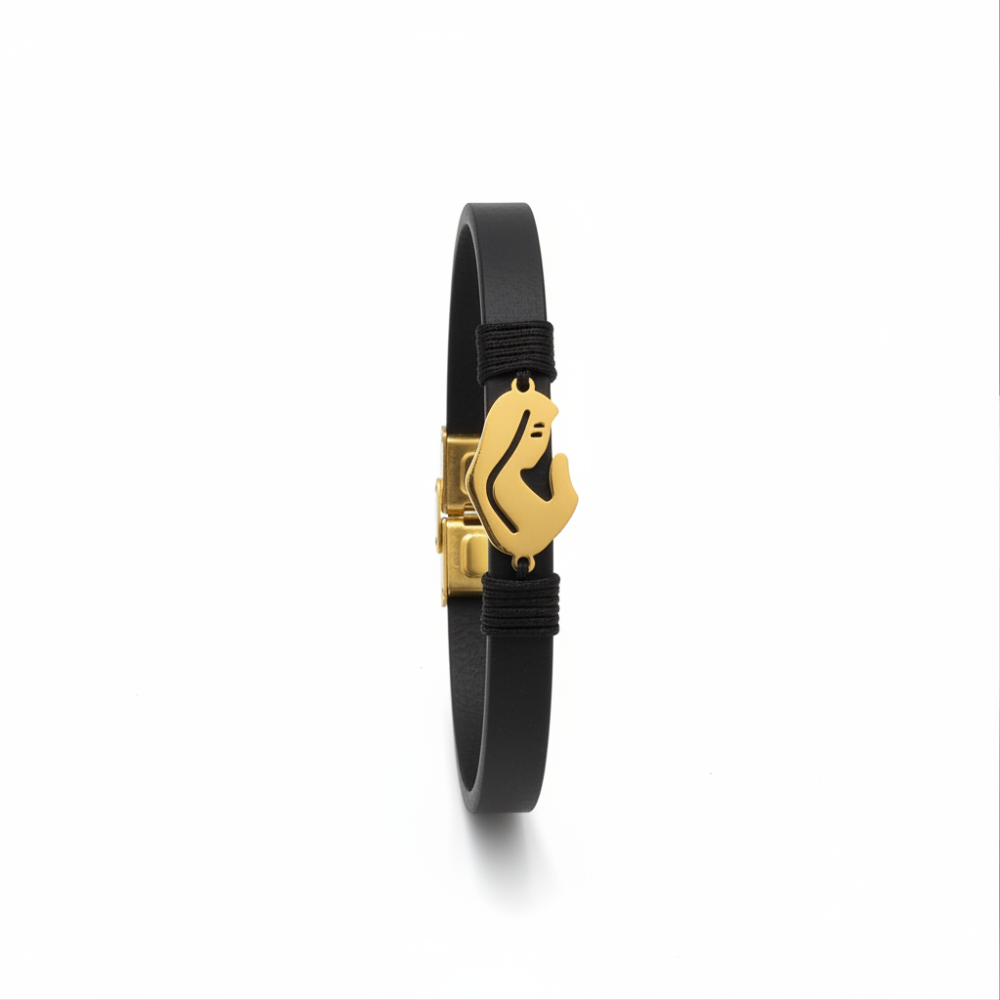 Black leather bracelet with gold mother and child charm on white background